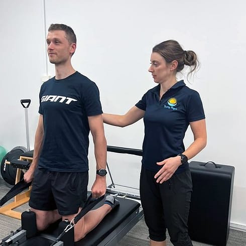 Physiotherapist assisting client with exercise physiology